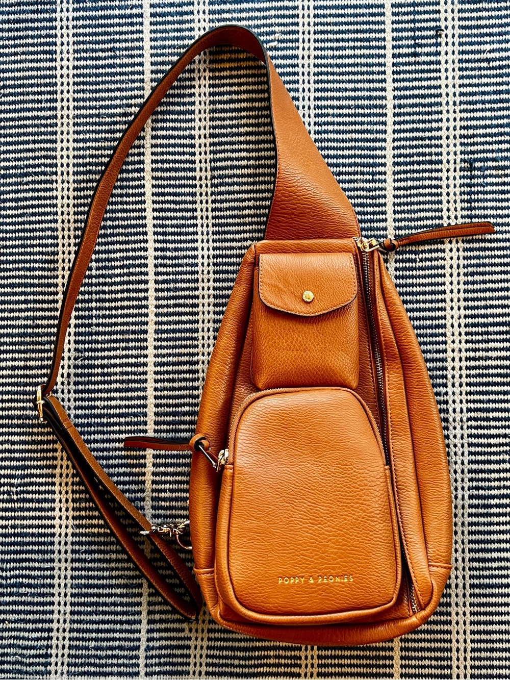 Poppy & peonies tan leather sling backpack w multi pockets and compartments